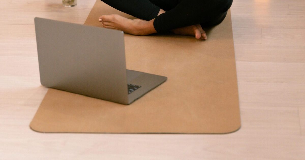 pexels-photo-5890702-5890702 African American woman practicing yoga and meditation indoors with a laptop.